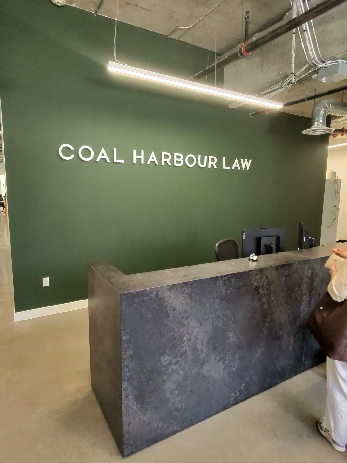 Coal Harbour Law reception area with the firm’s wall signage